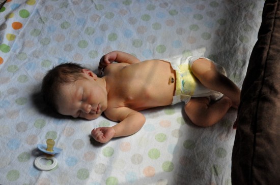 Kyler Porter newborn photo - sleeping in his pack and play